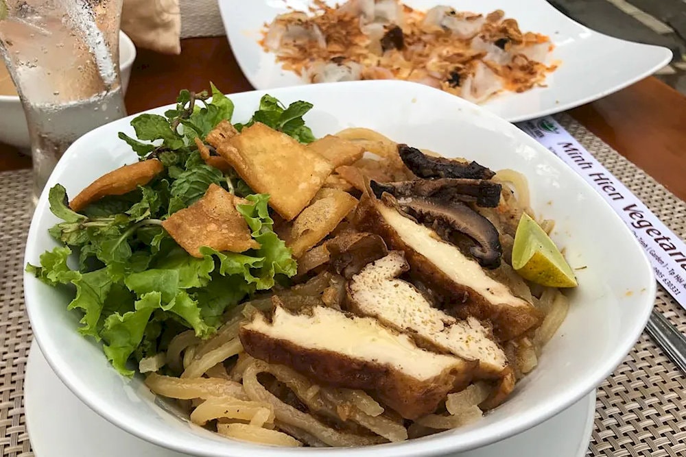 Vegetarian Cao Lau with characteristic chewy noodles, fresh green vegetables, and rich and pure sauce 